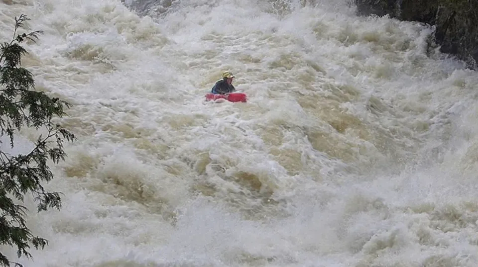 Josh Galt riverboarding a flooded river in Canada