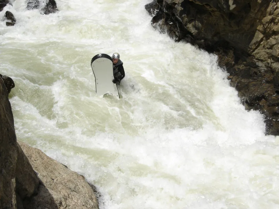 Josh Galt with his riverboard in the falls of Rigor Mortis, a class 5 rapid on Clear Creek, Colorado
