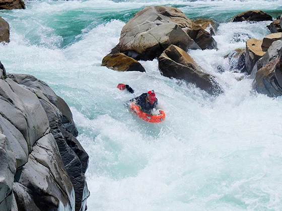 Josh Galt riverboarding big whitewater in a granite gorge on the Kiyotsu